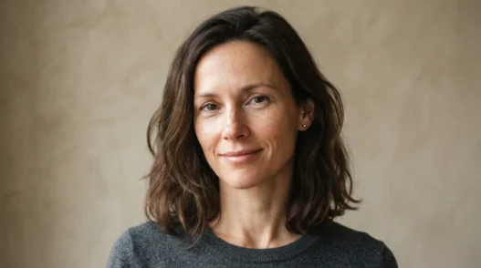 Woman with collarbone-length hair relaxed and unstyled against oat backdrop in ordinary daylight