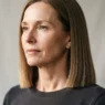 Woman with fine straight hair in a blunt collarbone-length bob, side lit to show clean weight line at ends