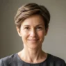 Woman with soft taper grown-out pixie cut showing clean nape and longer crown in natural daylight