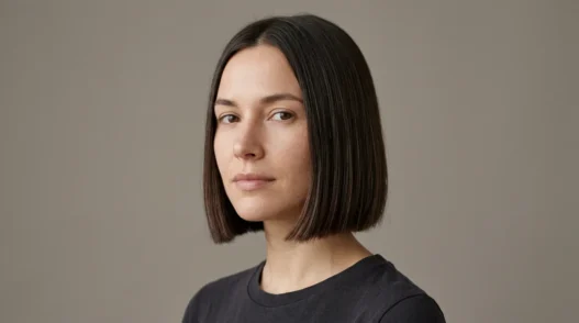 Woman with neat chin length bob with blunt ends in studio light