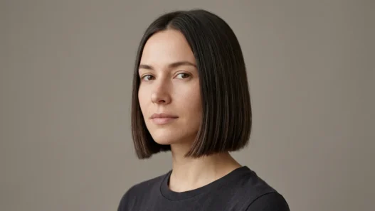 Woman with neat chin length bob with blunt ends in studio light