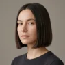 Woman with neat chin length bob with blunt ends in studio light